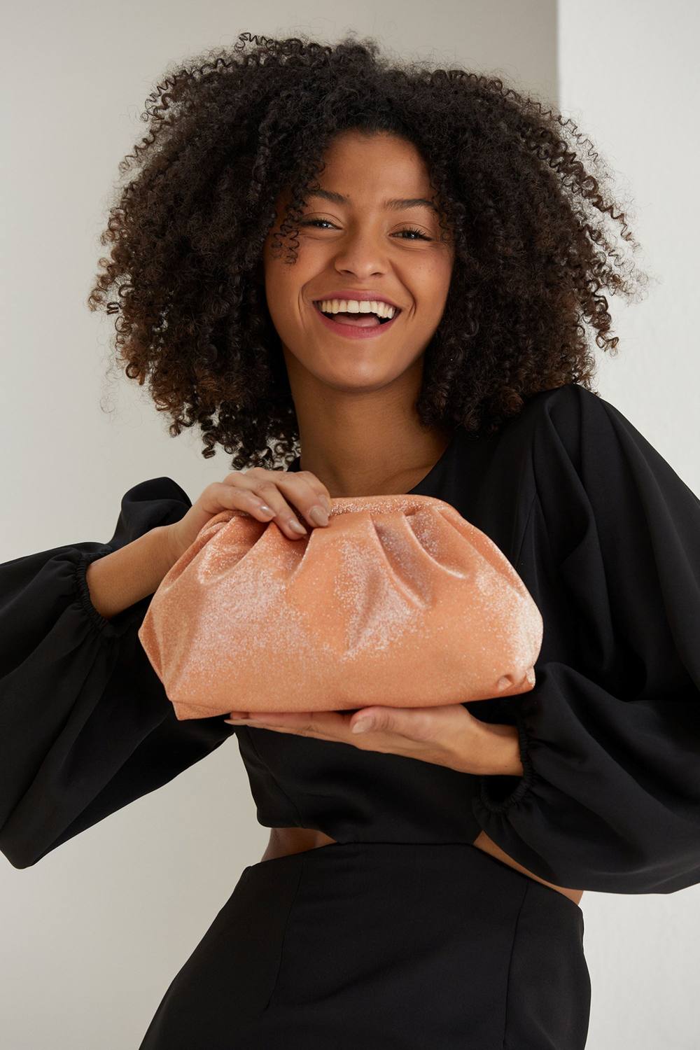 Belissh Women's Shimmery Pouch Bag With Detachable Crossbody Strap in Pale Orange